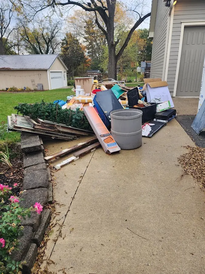 Dumpster being loaded with debris for Estate Cleanout Dumpster Rental in Lake Stevens